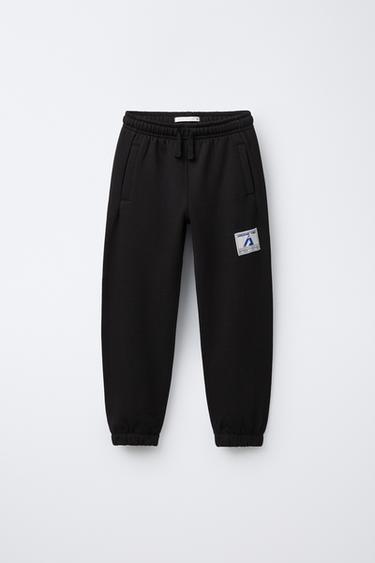 JOGGING TROUSERS WITH LABEL - Black by Zara