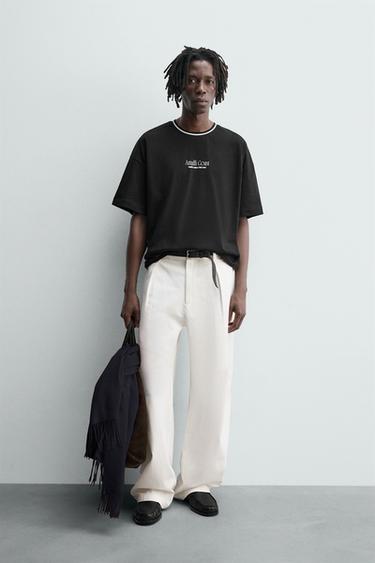 T-SHIRT WITH TEXTURED SLOGAN PRINT - Black by Zara - Image 0
